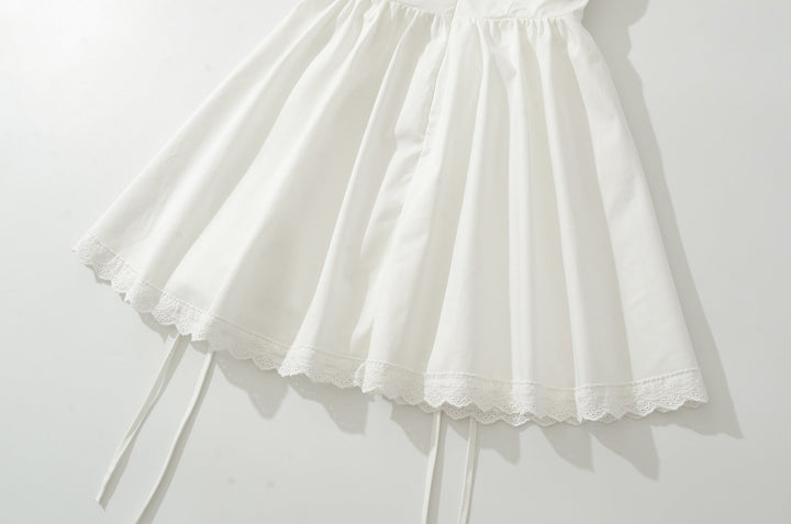 A-line mini dress with tie and button embellishments – Vanessa