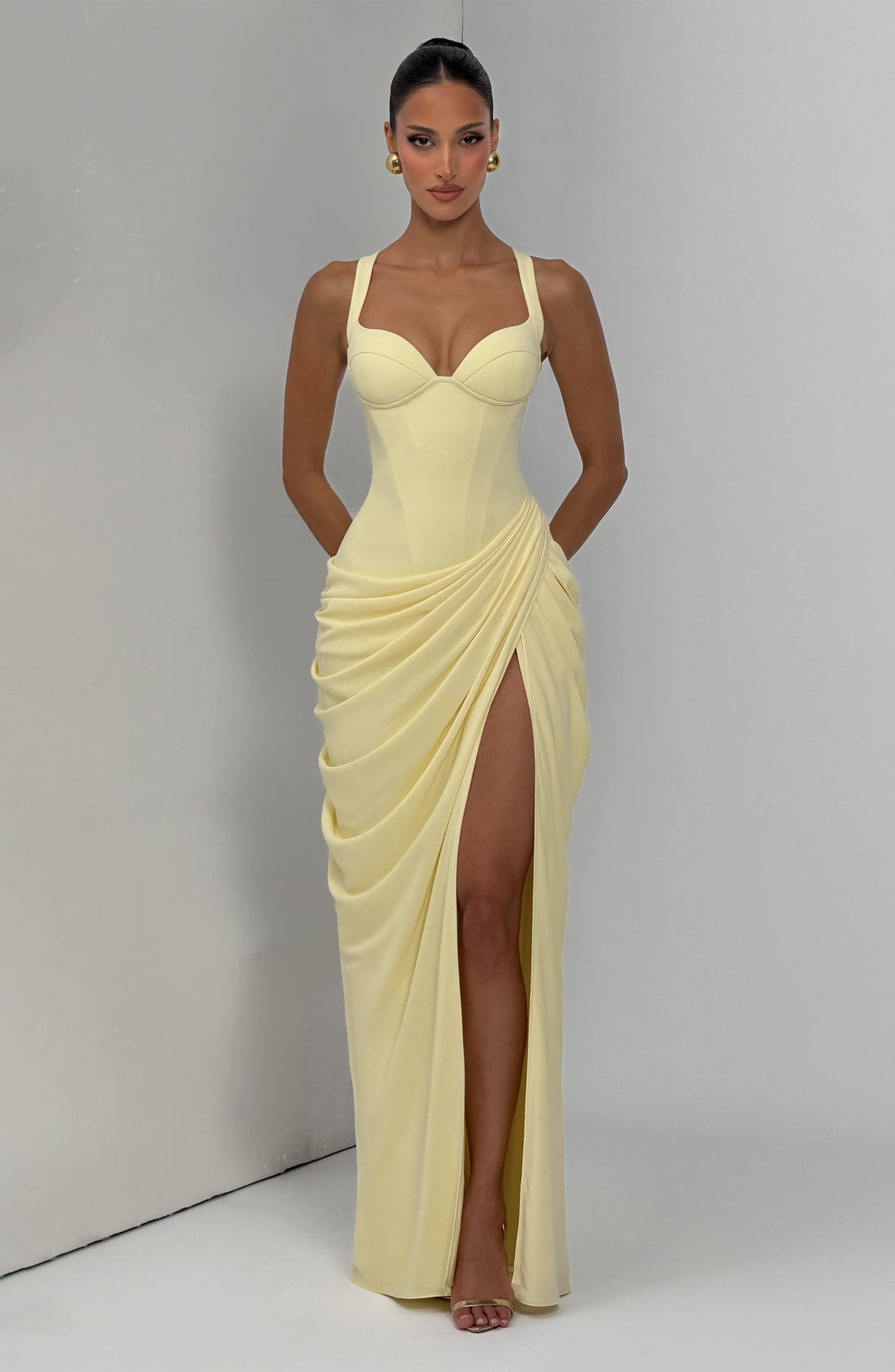 Layla maxi dress with a slit, pleats, corset design, back tie, and waist-cinching fit