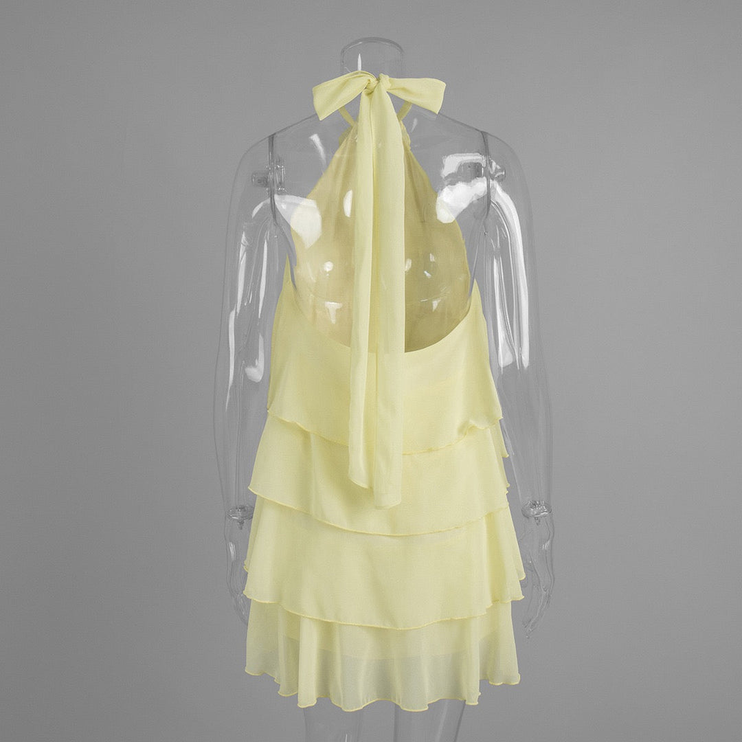 Lily tiered chiffon ruffle mini dress with a neck tie, open back, and floral trim