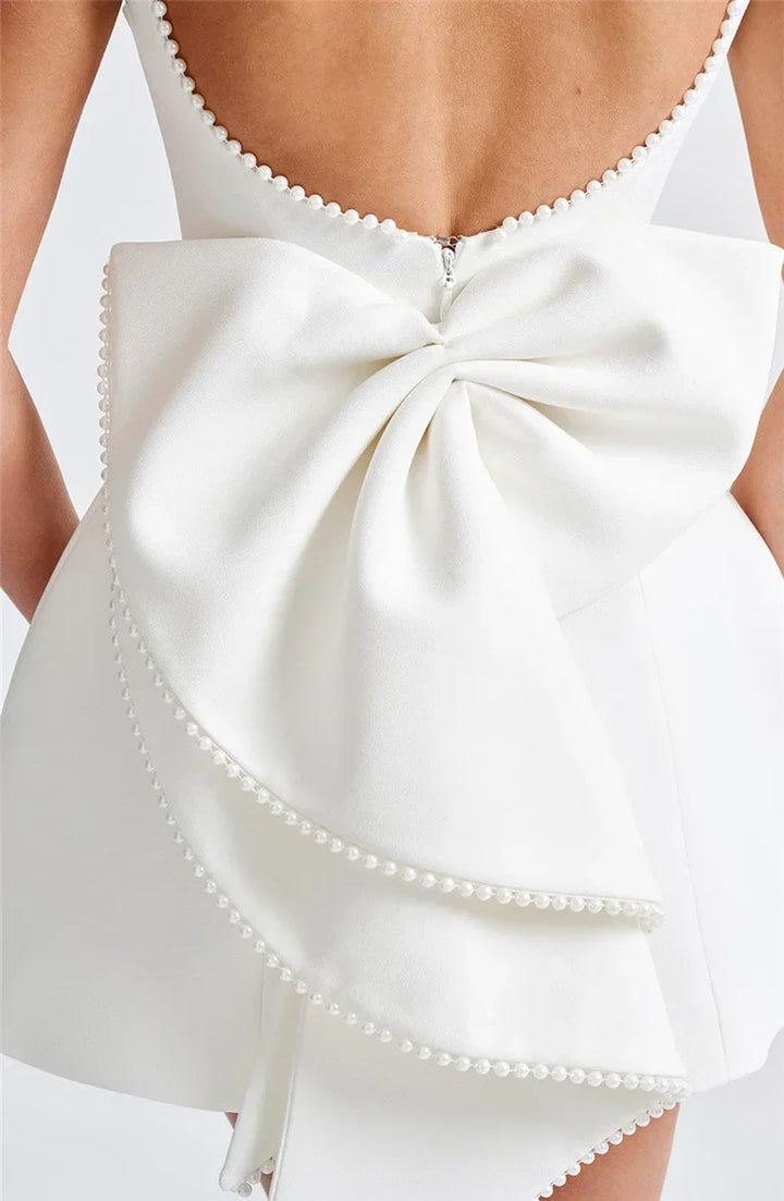 Open-back A-line mini dress with pearl and bow decoration on back - April