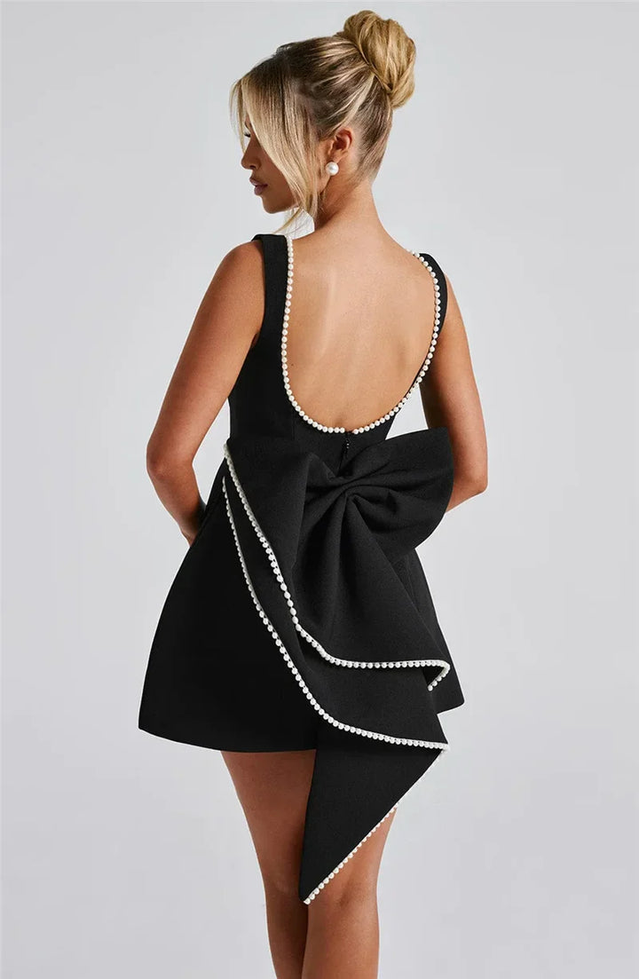 Open-back A-line mini dress with pearl and bow decoration on back - April
