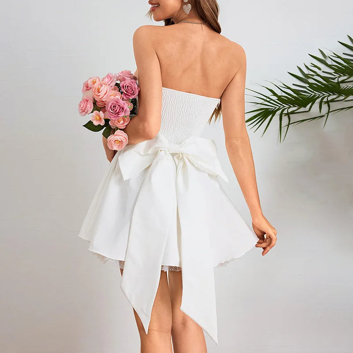 Strapless mini dress with bow detail on the back and added tulle underskirt - Novalee