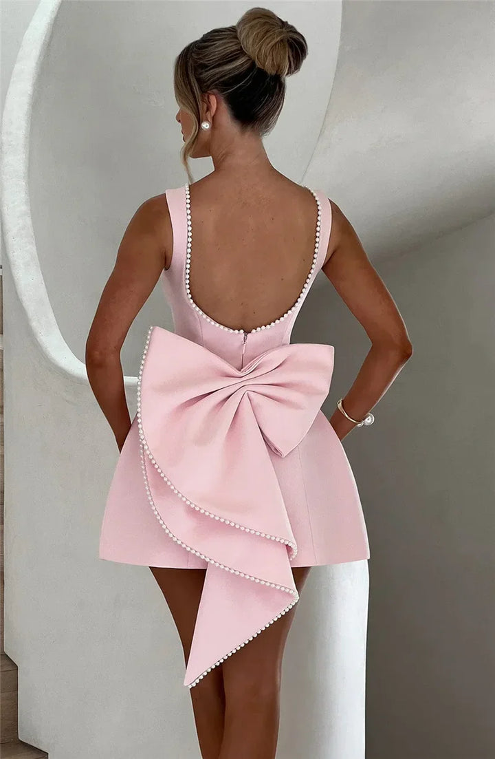 Open-back A-line mini dress with pearl and bow decoration on back - April