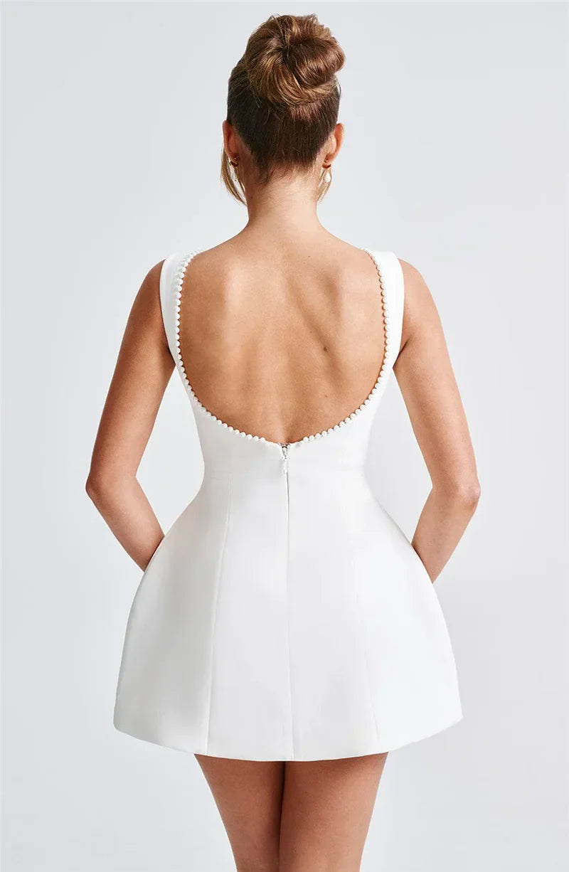 Open-back A-line mini dress with pearl and bow decoration on back - April