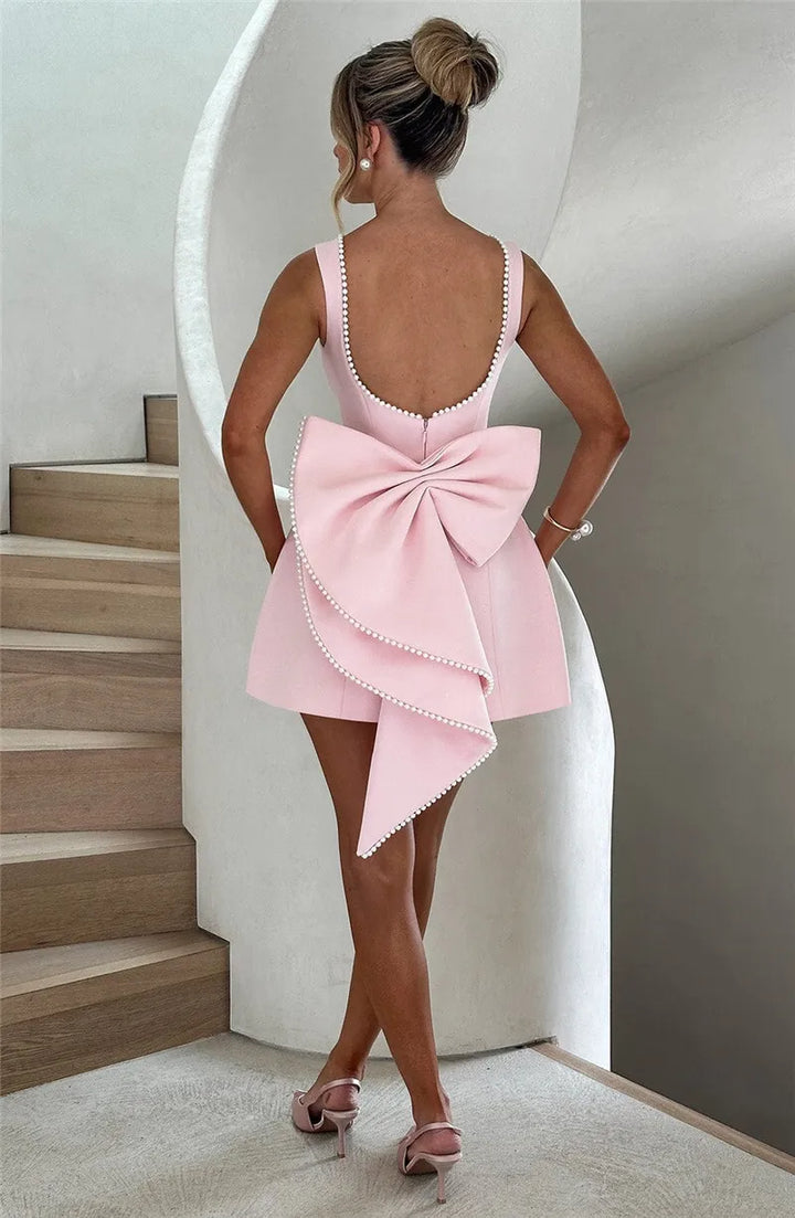 Open-back A-line mini dress with pearl and bow decoration on back - April