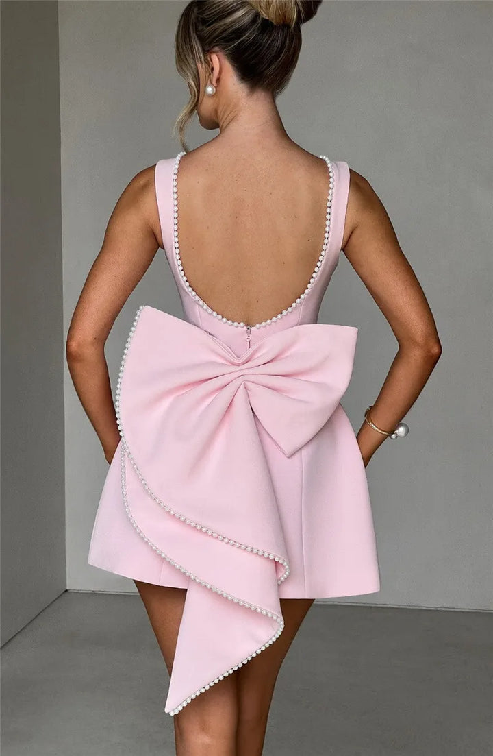 Open-back A-line mini dress with pearl and bow decoration on back - April