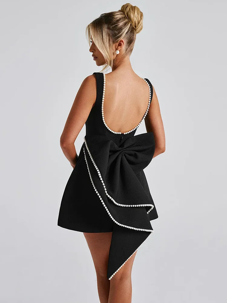 Open-back A-line mini dress with pearl and bow decoration on back - April