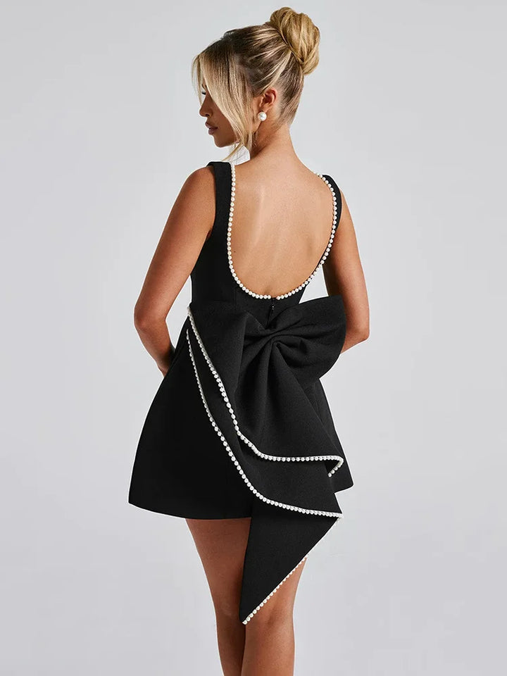 Open-back A-line mini dress with pearl and bow decoration on back - April