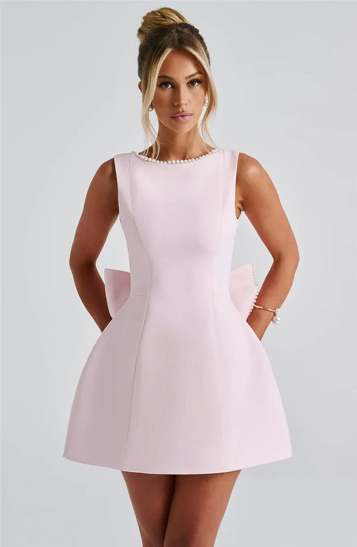 Open-back A-line mini dress with pearl and bow decoration on back - April