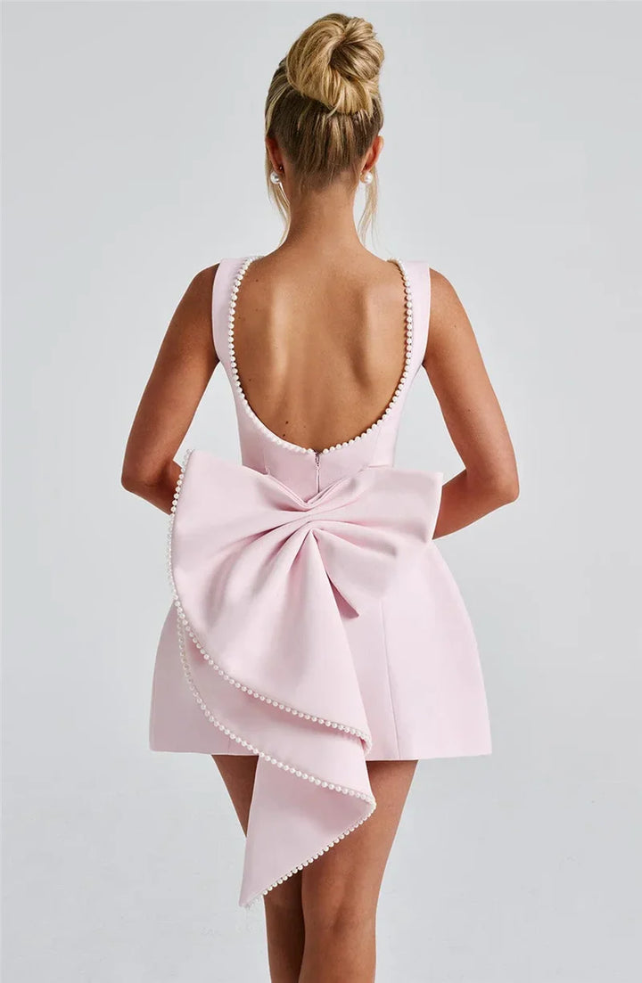 Open-back A-line mini dress with pearl and bow decoration on back - April