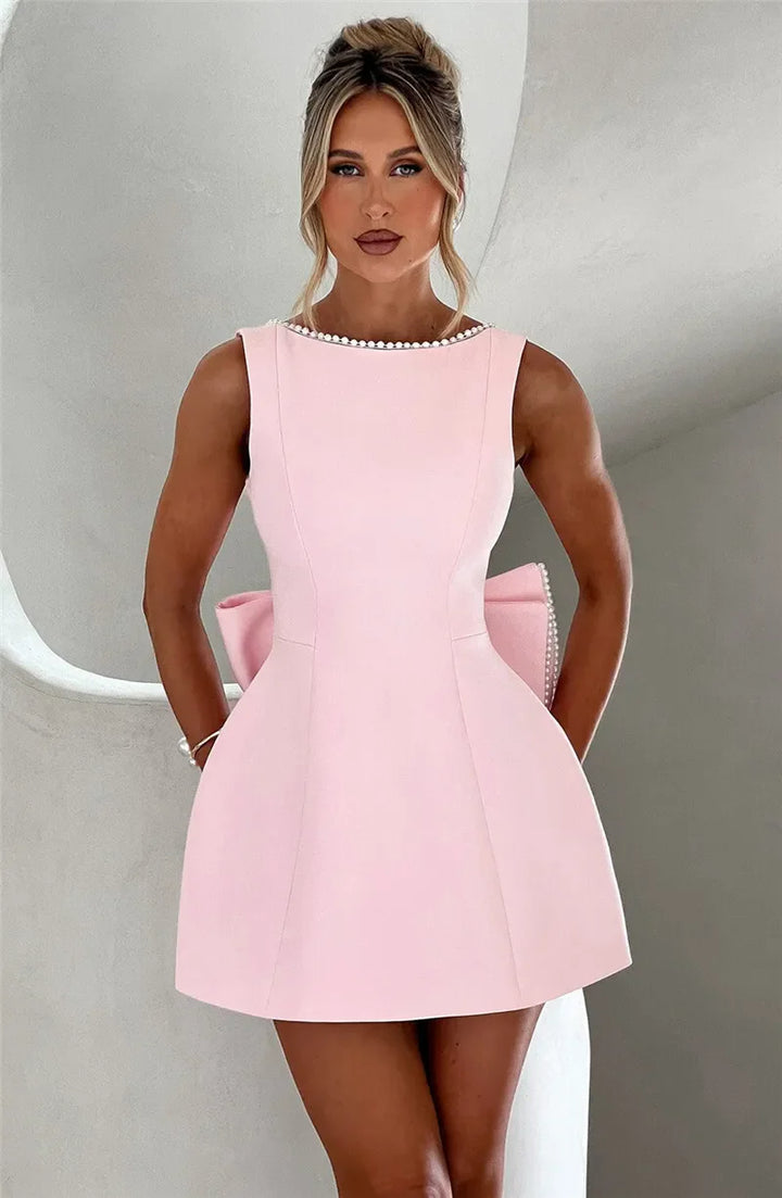 Open-back A-line mini dress with pearl and bow decoration on back - April