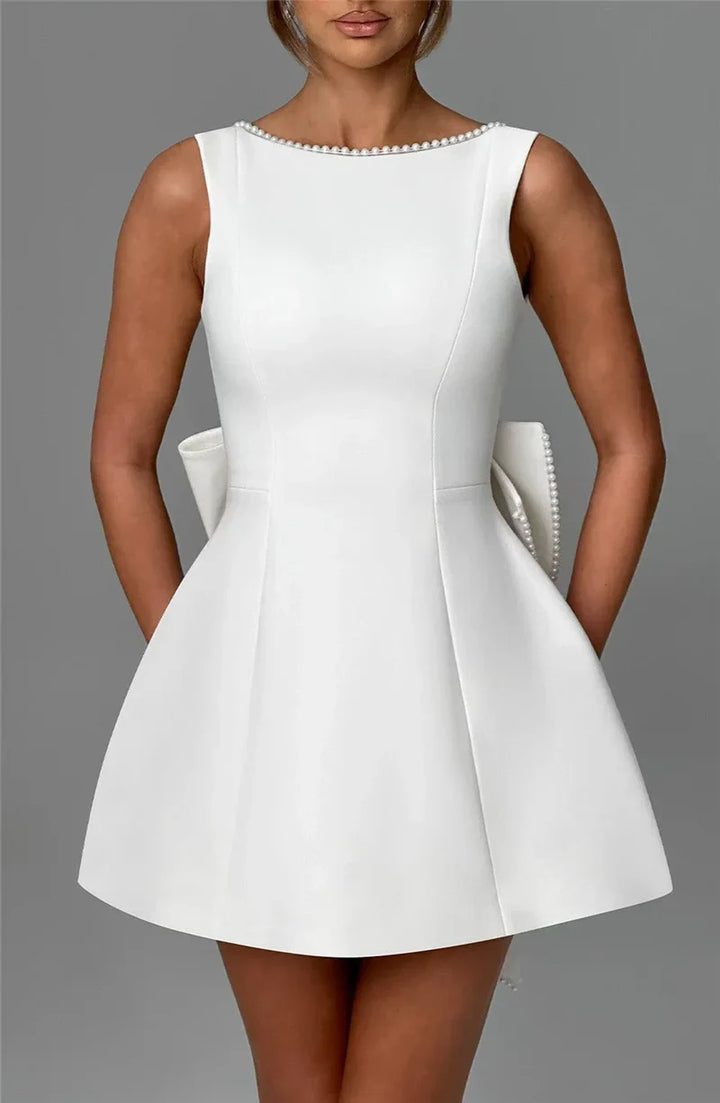 Open-back A-line mini dress with pearl and bow decoration on back - April