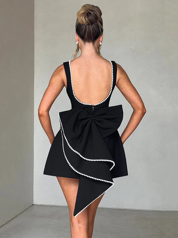 Open-back A-line mini dress with pearl and bow decoration on back - April